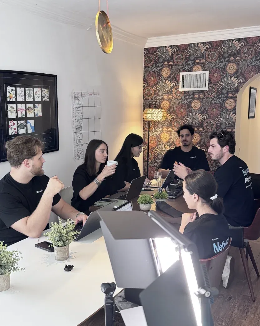 Entrepreneurs working together at the dining table of a Miami coliving house