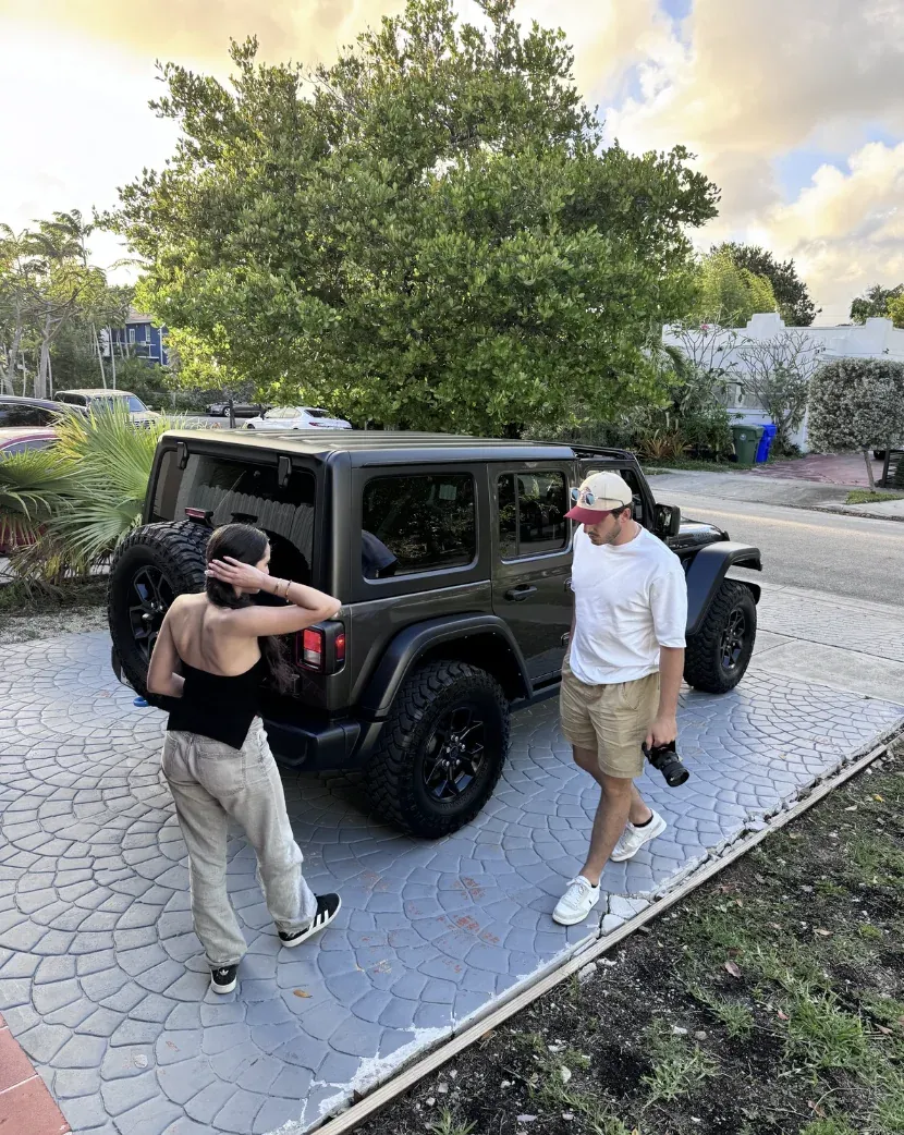 Two coliving members next to a jeep outside a Miami coliving house