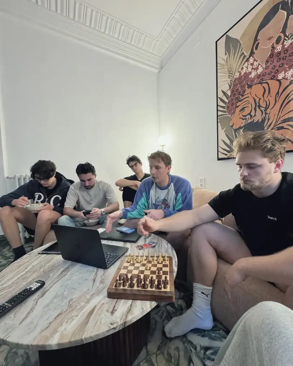 Entrepreneurs relaxing and working in the living room of a Valencia coliving
